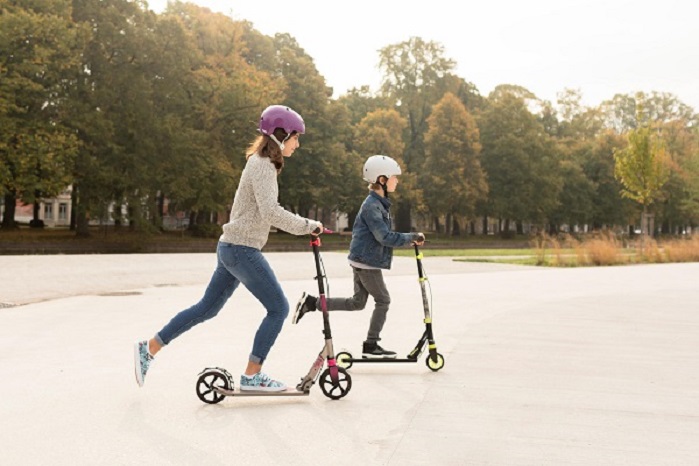 Girls riding kick scooters
