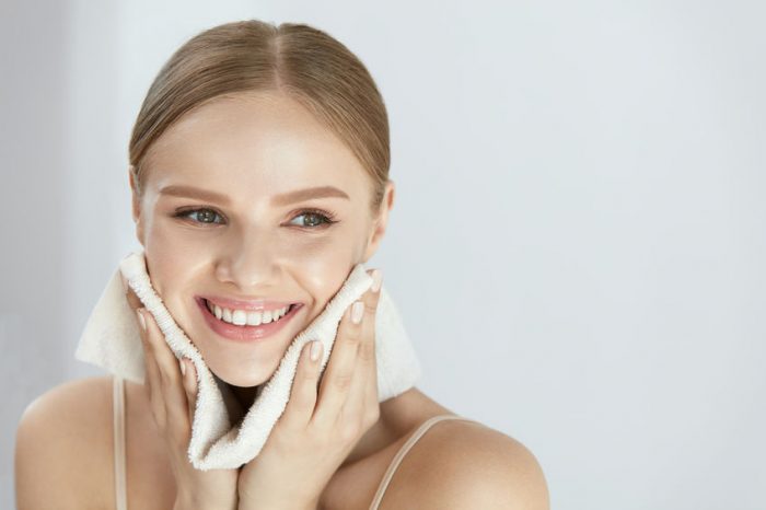 Cleaning Face Skin. Beautiful Happy Girl Washing Face