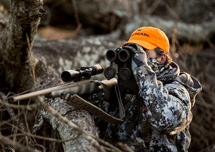 woman wearing orange hunting hat while hunting