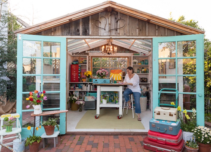 woman painting in garden shed 