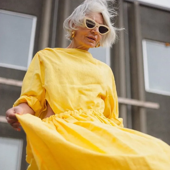 woman over 50 wearing yellow dress 