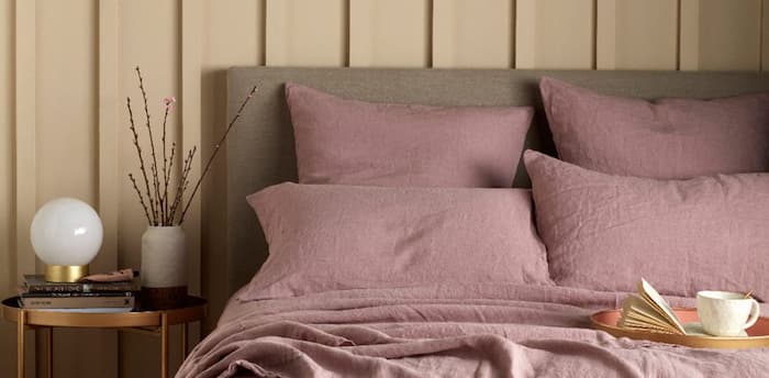 Dark rose bedding pillows with wooden details on side