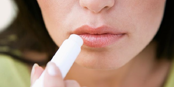 Applying lip balm