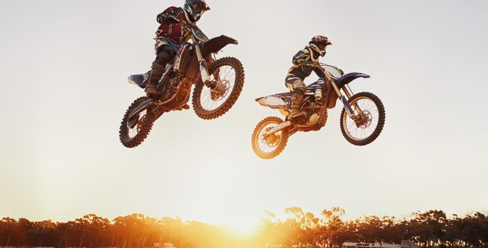 A shot of two motocross riders in midair during a race